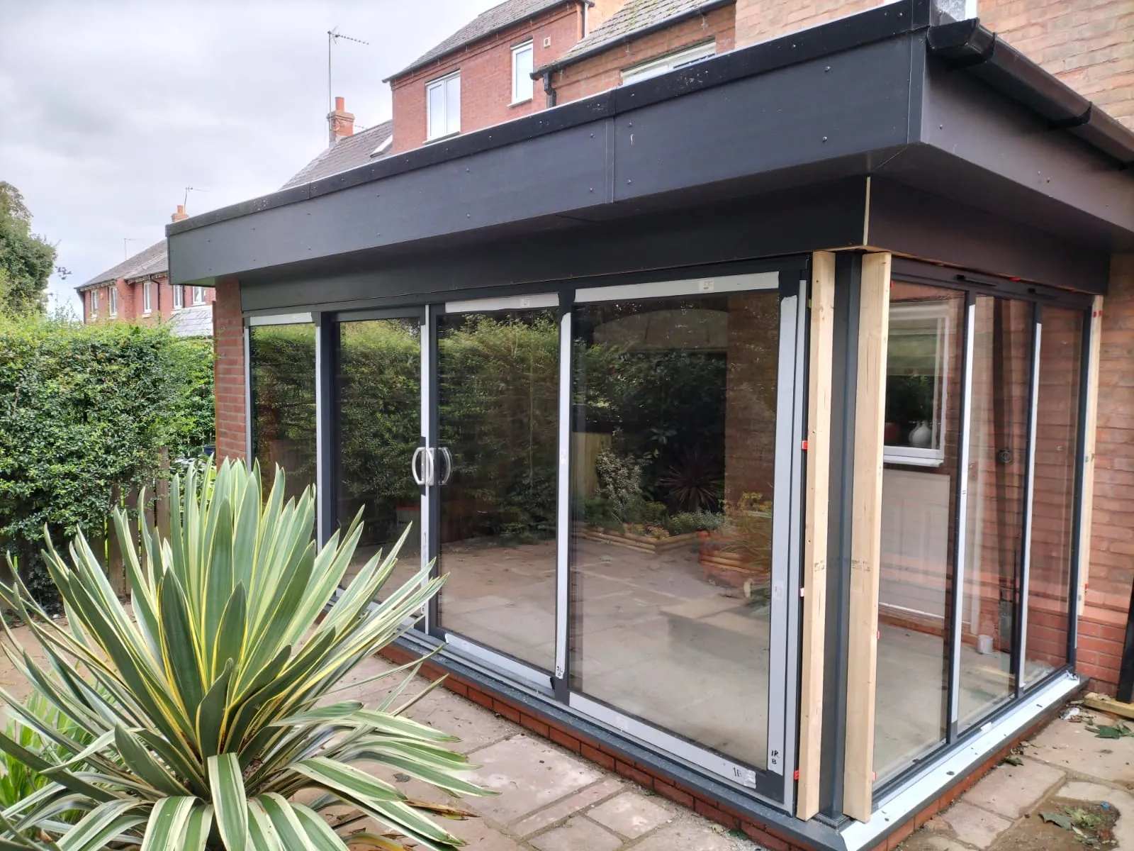 A house with a patio and sliding glass doors.
